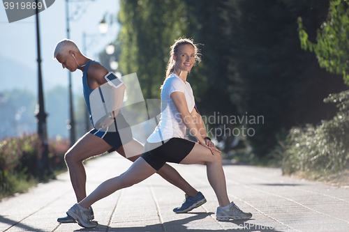 Image of couple warming up and stretching before jogging