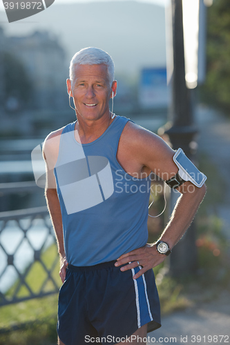 Image of portrait of handsome senior jogging man