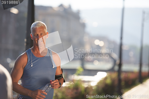 Image of portrait of handsome senior jogging man