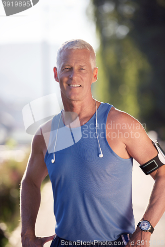 Image of portrait of handsome senior jogging man