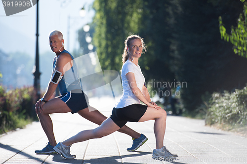 Image of couple warming up and stretching before jogging