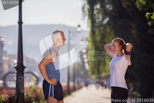 Image of jogging couple planning running route  and setting music