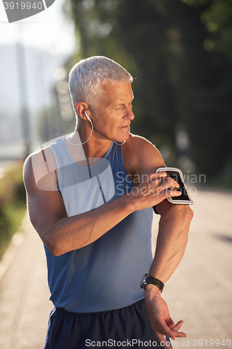 Image of portrait of handsome senior jogging man