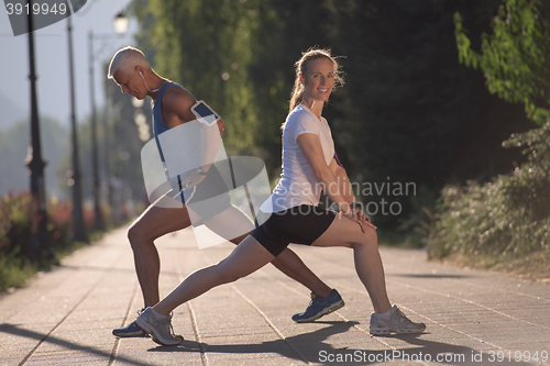 Image of couple warming up and stretching before jogging