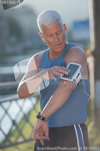 Image of portrait of handsome senior jogging man