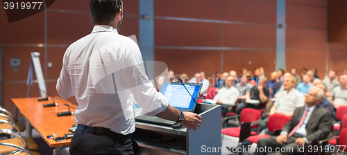 Image of Public speaker giving talk at Business Event.