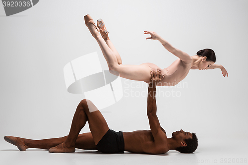 Image of Couple of ballet dancers posing over gray background