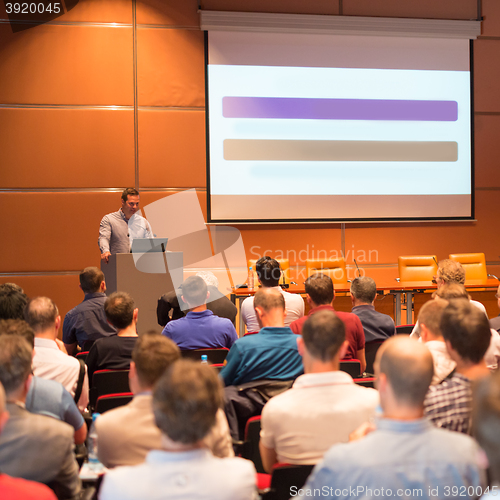 Image of Business speaker giving a talk in conference hall.