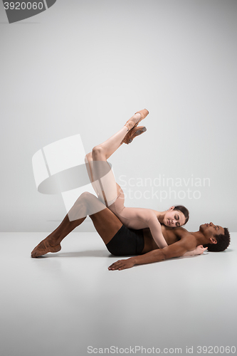 Image of Couple of ballet dancers posing over gray background