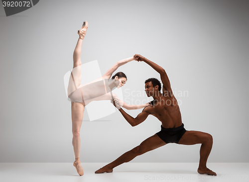 Image of Couple of ballet dancers posing over gray background