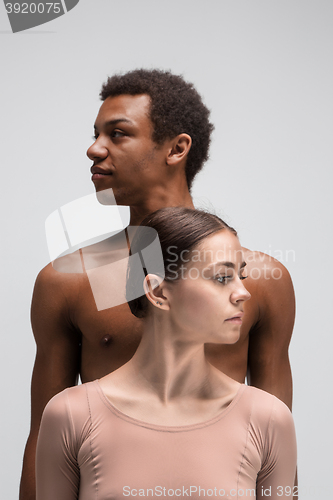 Image of Couple of ballet dancers posing over gray background