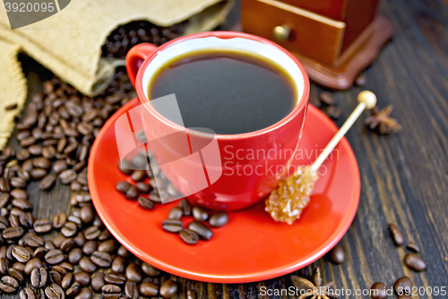 Image of Coffee in red cup with sugar and bag on board