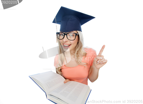 Image of student woman in mortarboard with encyclopedia