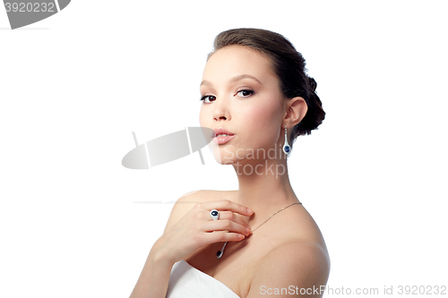 Image of beautiful woman with earring, ring and pendant