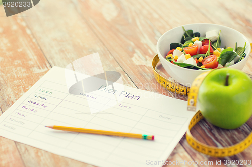 Image of close up of diet plan and food on table