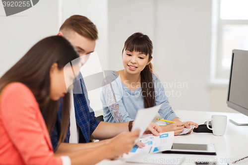 Image of happy creative team or students working at office