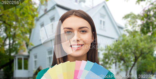 Image of smiling young woman with color swatches