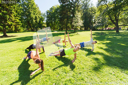 Image of group of happy friends exercising outdoors