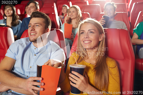 Image of happy friends watching movie in theater