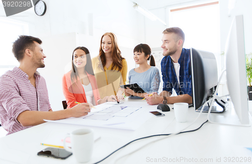 Image of happy creative team or students working at office