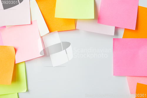 Image of close up of blank paper stickers on cork board