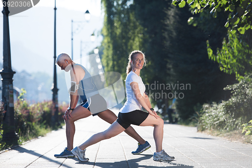 Image of couple warming up and stretching before jogging