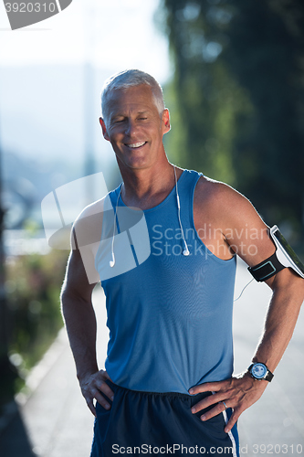 Image of portrait of handsome senior jogging man