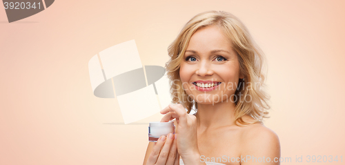 Image of happy woman with cream jar