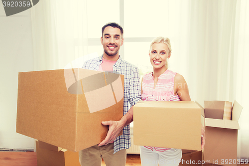 Image of couple with big cardboard boxes moving to new home