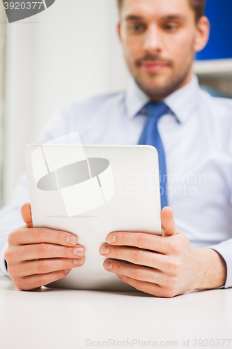 Image of close up of businessman with tablet pc in office