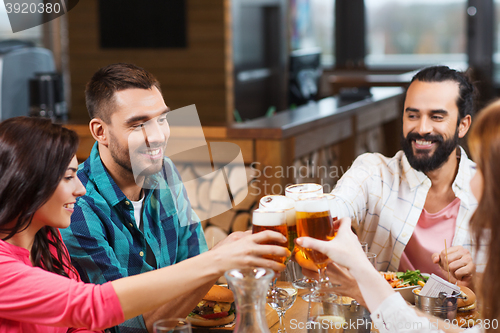 Image of friends dining and drinking beer at restaurant