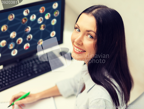 Image of smiling businesswoman with computer