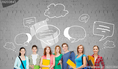 Image of group of teenage students with folders and bags