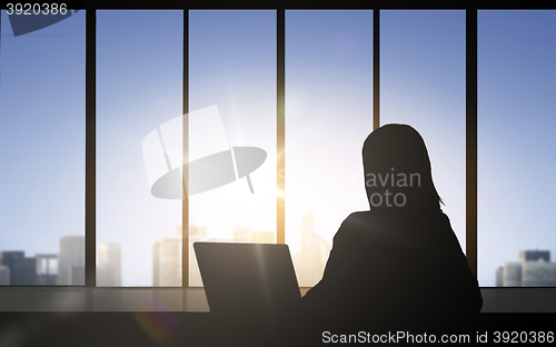Image of silhouette of business woman with laptop