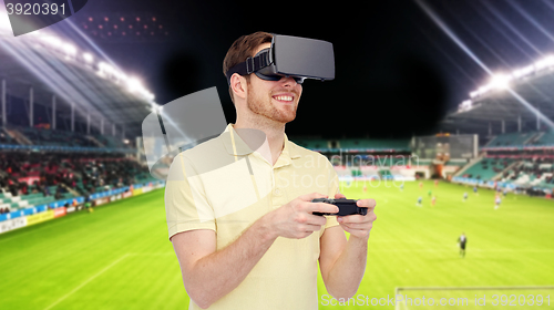 Image of man in virtual reality headset over football field