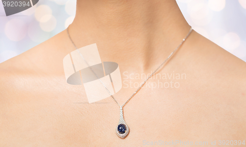 Image of close up of beautiful woman neck with pendant