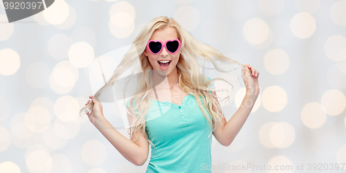 Image of happy young blonde woman or teenager in sunglasses