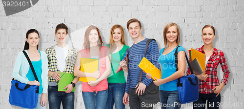 Image of group of teenage students with folders and bags