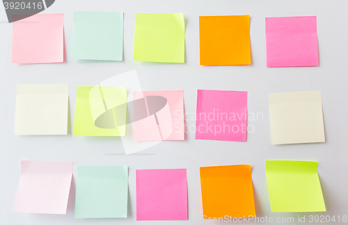 Image of close up of blank paper stickers on white board