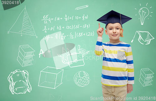 Image of boy in bachelor hat and eyeglasses over blackboard