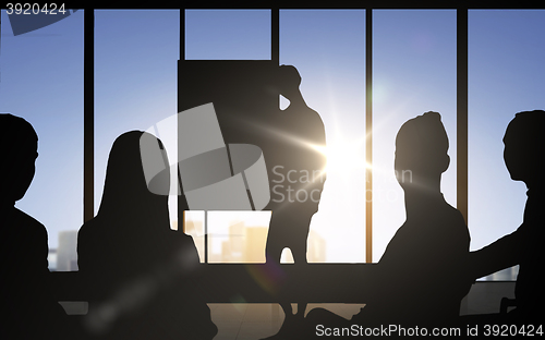 Image of business people silhouettes at meeting in office