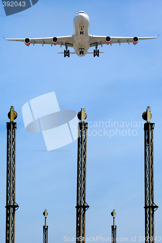 Image of Plane over lights in airport