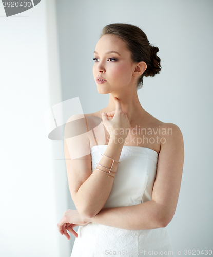 Image of beautiful asian woman with golden bracelet