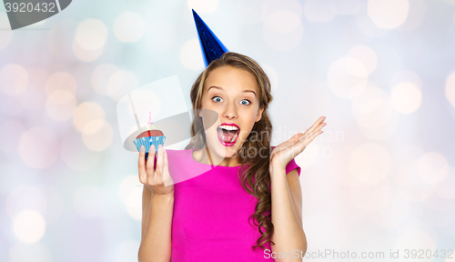 Image of happy woman or teen girl with birthday cupcake