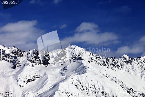 Image of View on snowy mountains in sunny day