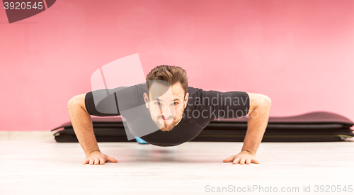 Image of Portrait of a Young Man Doing Pushups