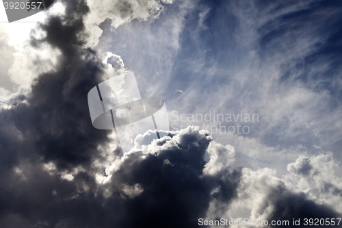 Image of Sunlight sky with dark storm clouds