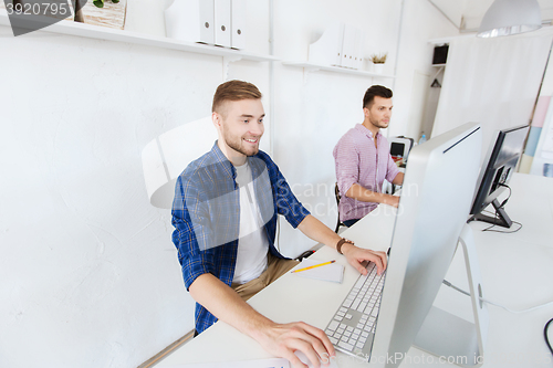 Image of creative man or student with computer at office