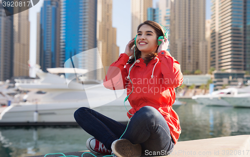 Image of happy young woman in headphones listening to music