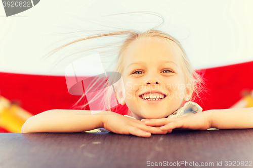 Image of happy little girl climbing on children playground